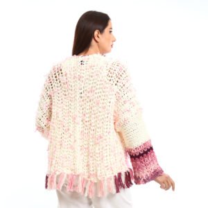 Handmade-looking crocheted open cardigan.is primarily cream-colored with pink featuring wide sleeves with color-blocked bands near the cuffs. - Image 4
