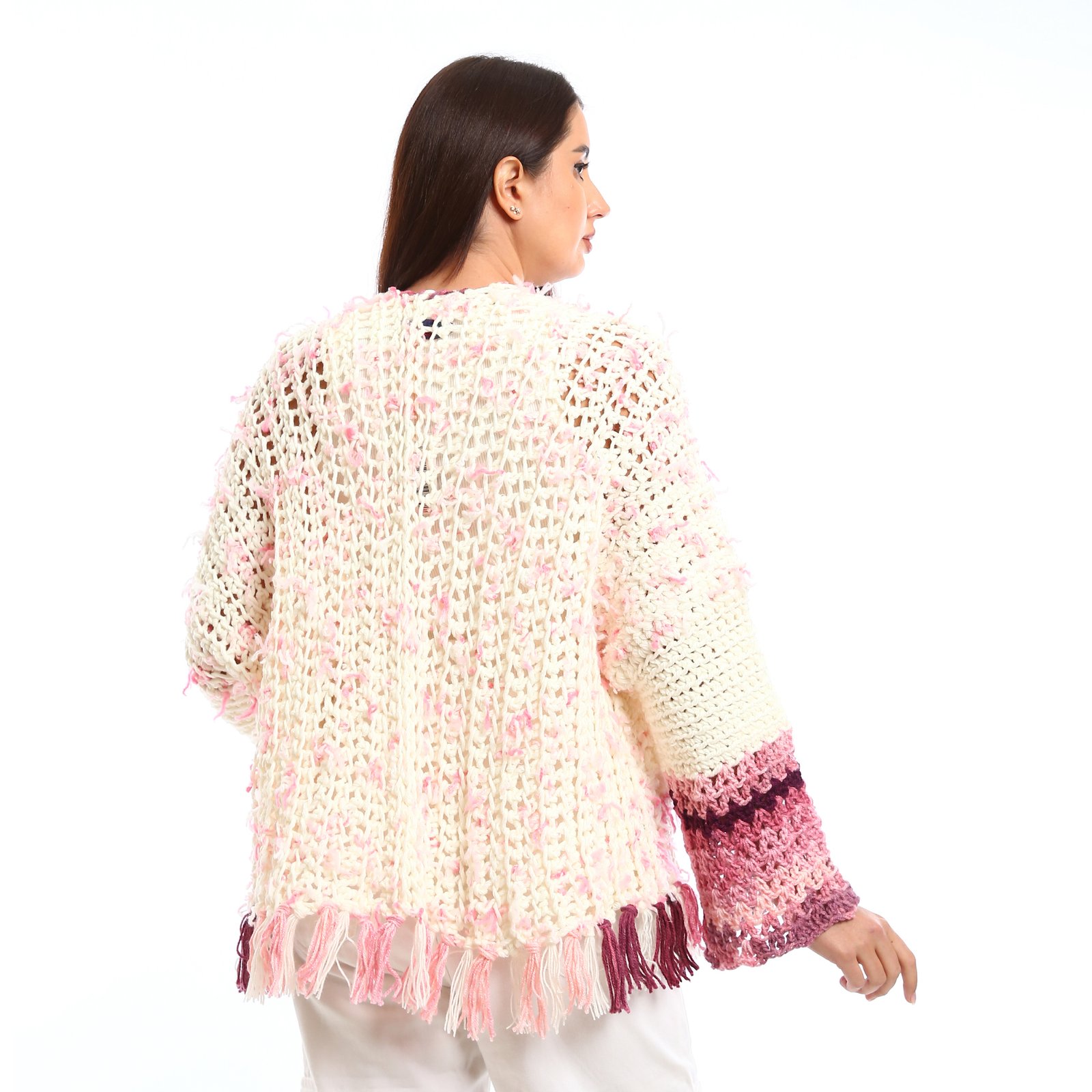 Handmade-looking crocheted open cardigan.is primarily cream-colored with pink featuring wide sleeves with color-blocked bands near the cuffs. - Image 4