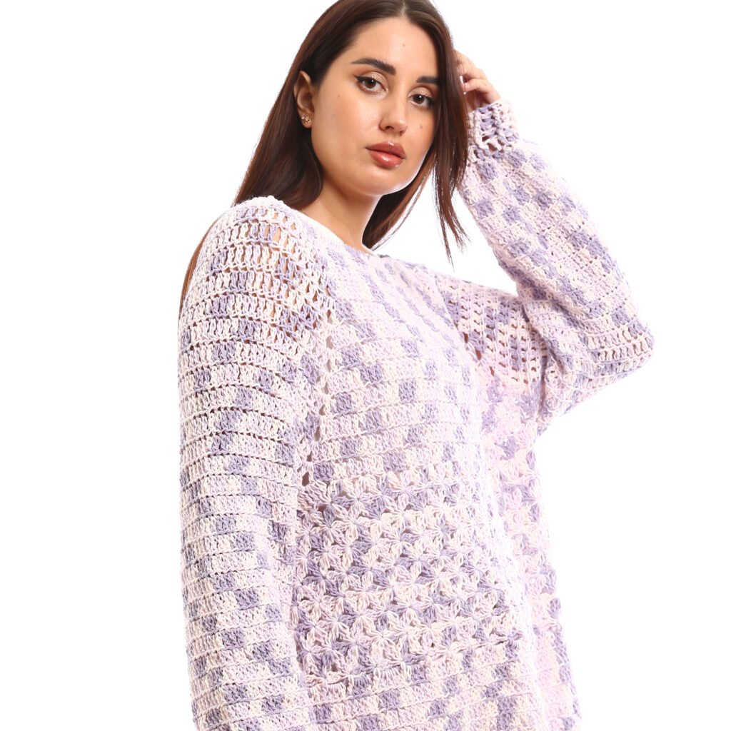 Handcrafted crochet pullover design with an airy, open-knit texture It comes in soft pastel shades of lavender blended with white