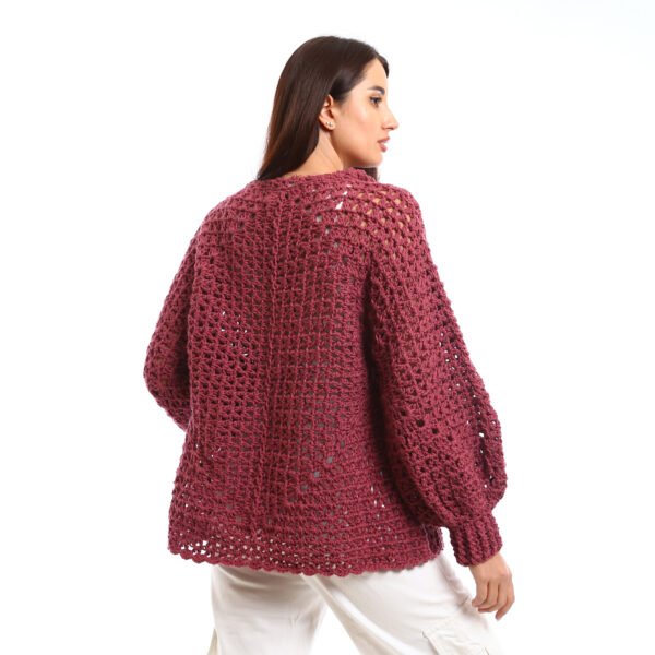 Handcrafted crocheted pullover in a rich burgundy tone. It features an open, textured stitch relaxed sleeves with slightly flared cuffs and a wide