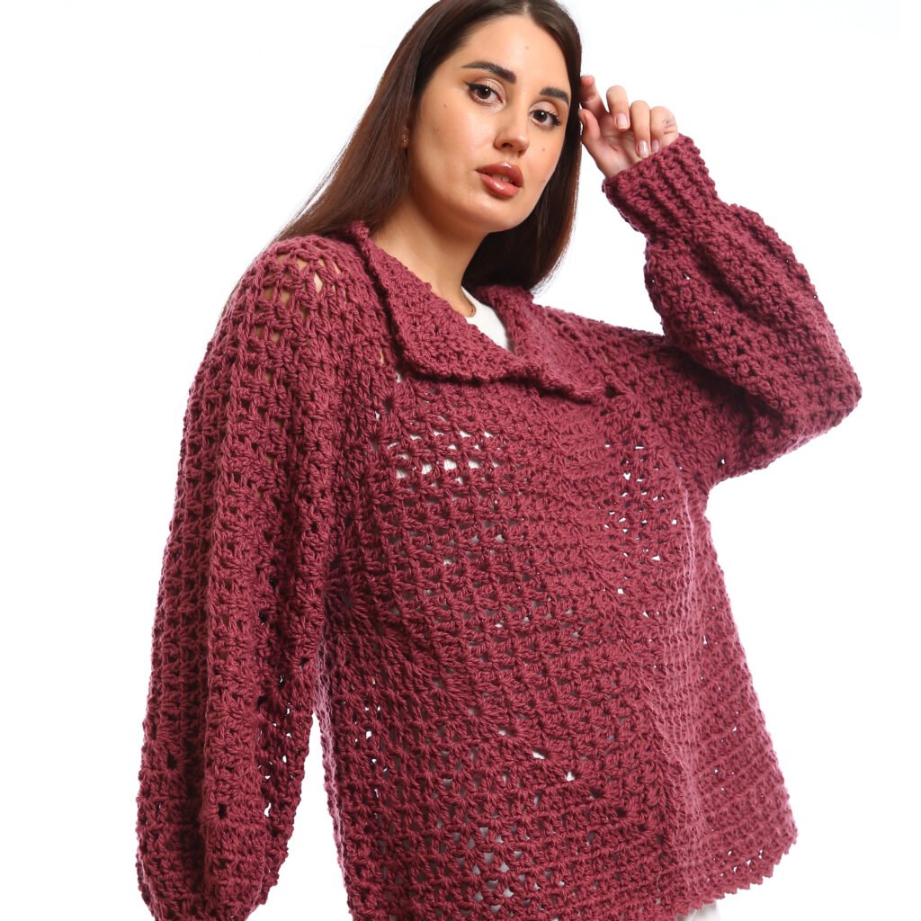 Handcrafted crocheted pullover in a rich burgundy tone. It features an open, textured stitch relaxed sleeves with slightly flared cuffs and a wide