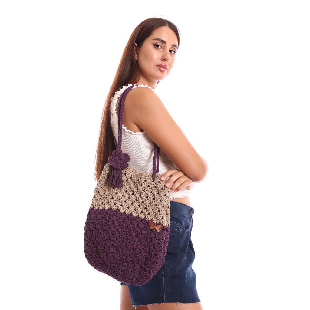 A handcrafted crochet tote bag featuring a two-tone
