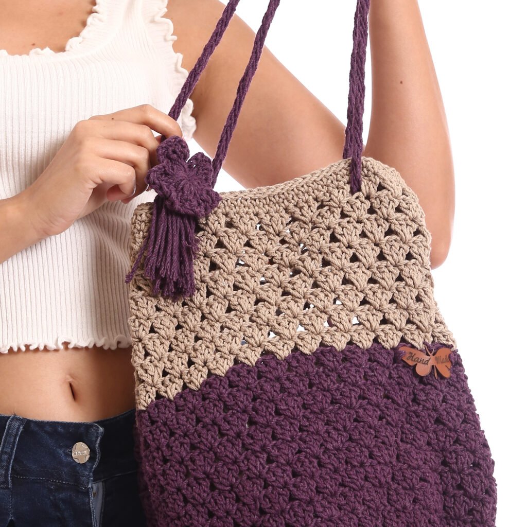 A handcrafted crochet tote bag featuring a two-tone