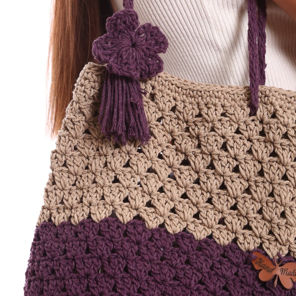 A handcrafted crochet tote bag featuring a two-tone