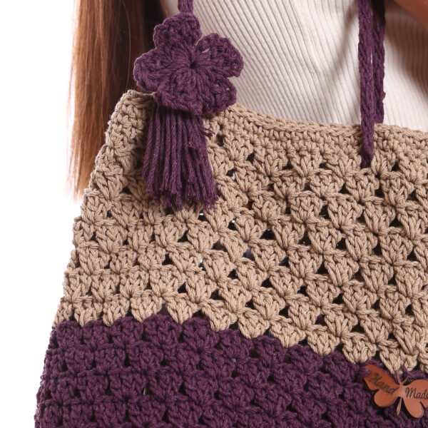 A handcrafted crochet tote bag featuring a two-tone